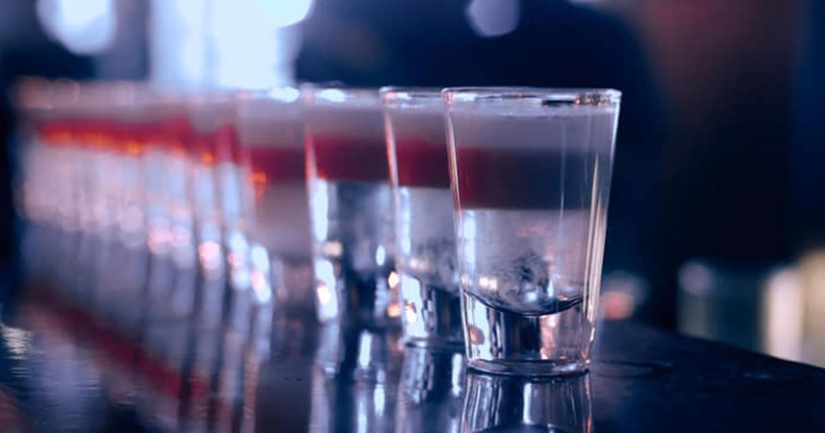 Shot Glasses Lined Up on Bar Counter